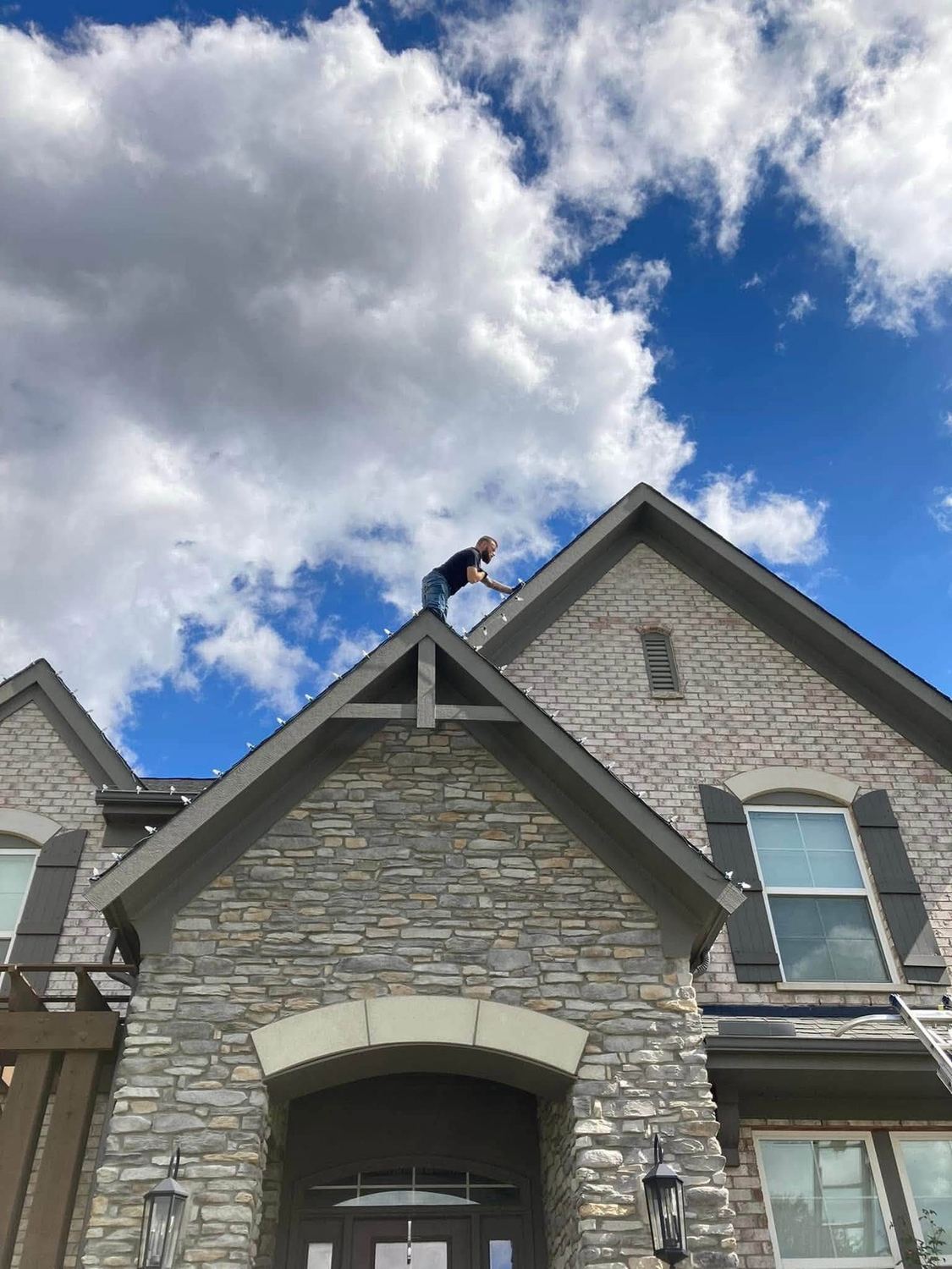 Up at the peak, setting the top line &mdash; Christmas light installation by Mike&rsquo;s Cincinnati Christmas Lights
