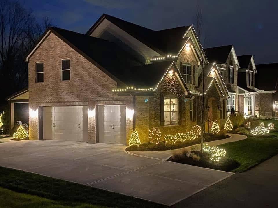 Brick two-story, roofline and bushes — Christmas light installation by Mike’s Cincinnati Christmas Lights